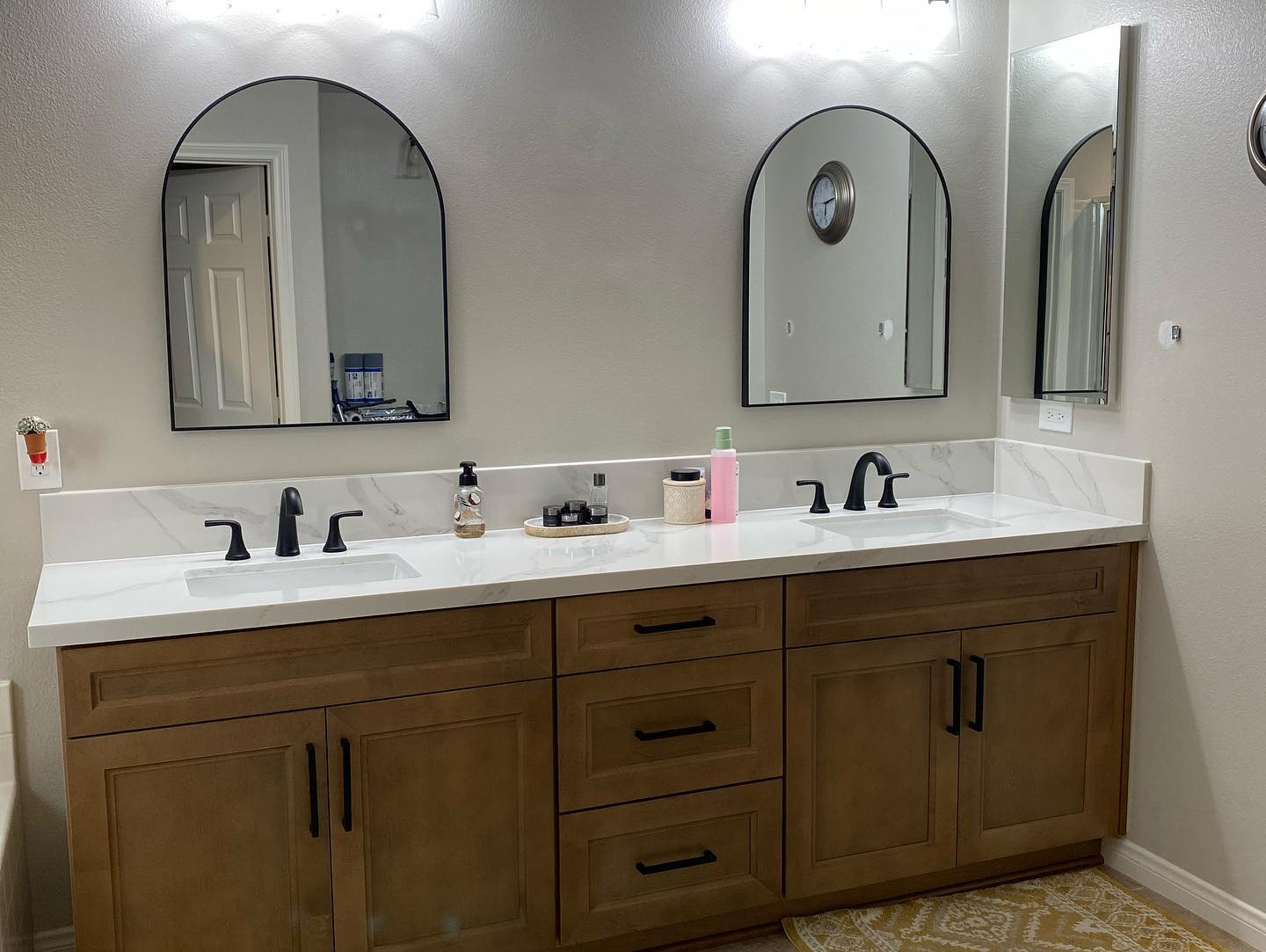 R&B project: wood double vanity under two arched black mirrors