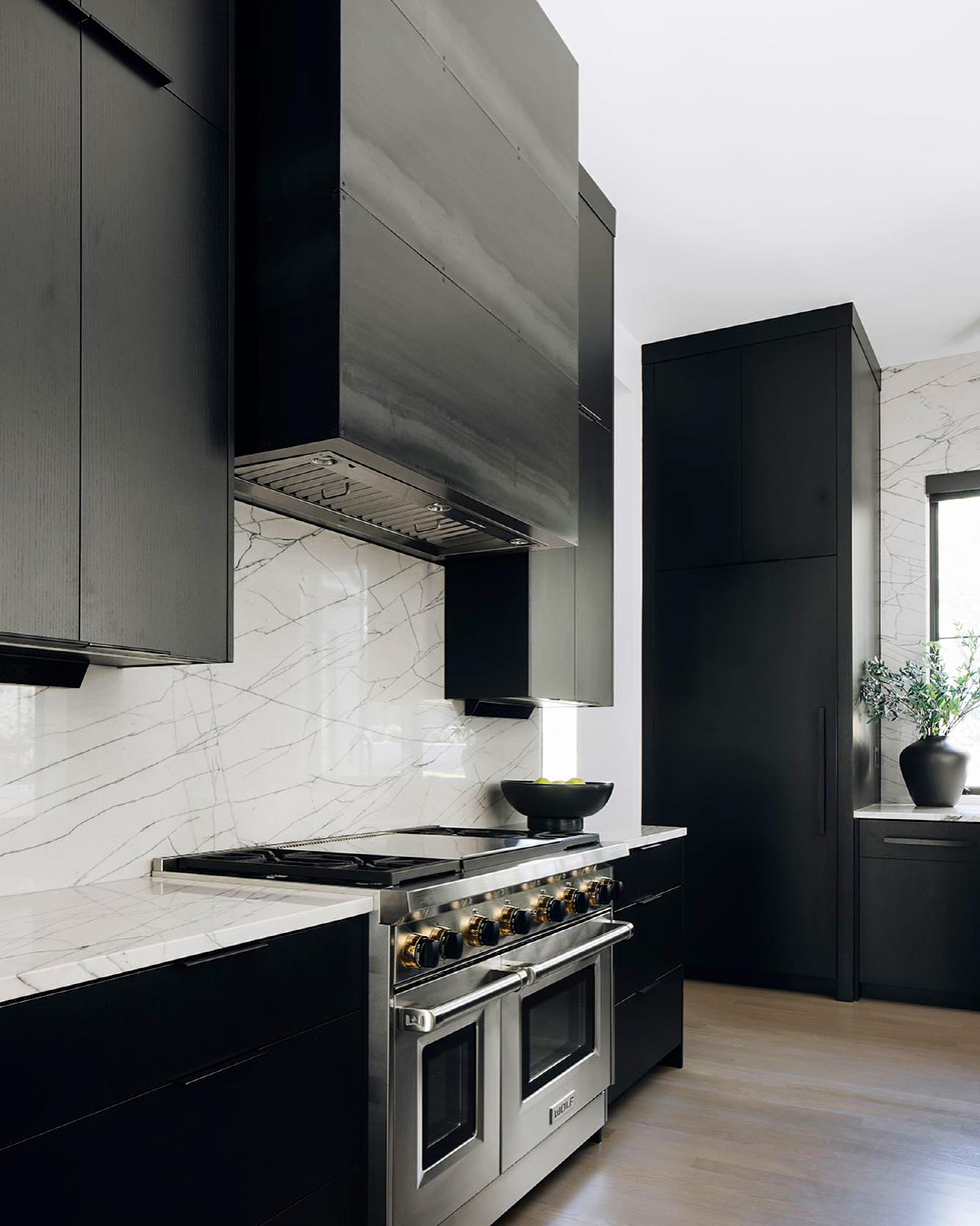 R&B project: black cabinets around a stainless professional range and hood