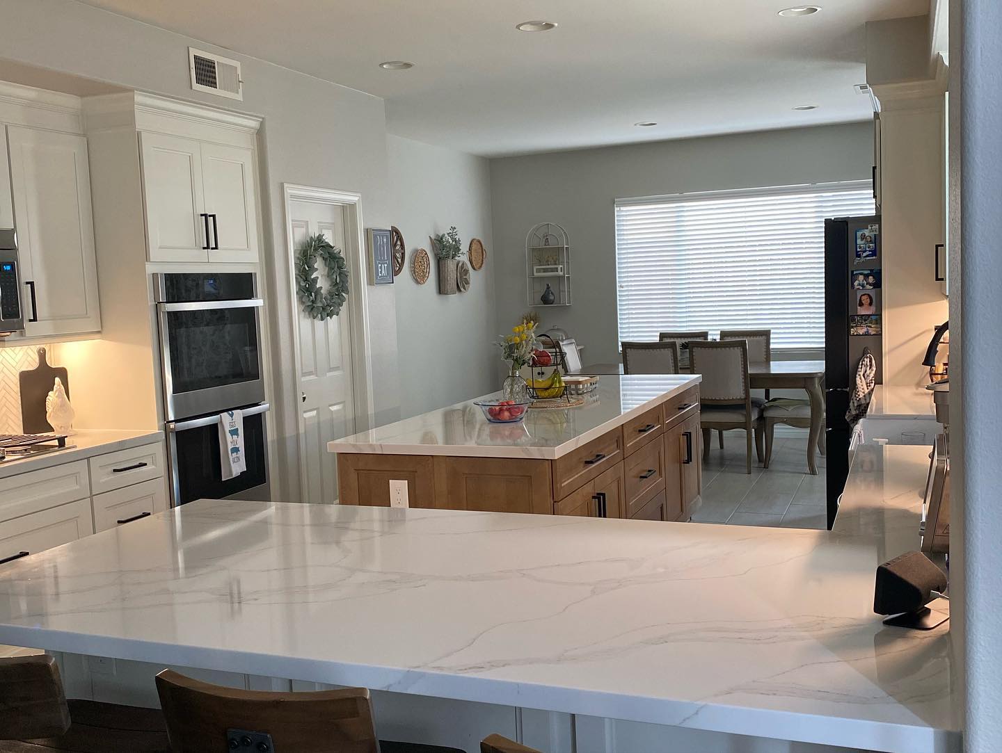 R&B project: marble-look peninsula and wood island across from wall ovens