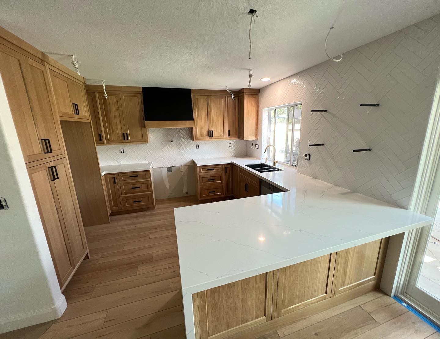 R&B project: oak cabinets with a white quartz peninsula