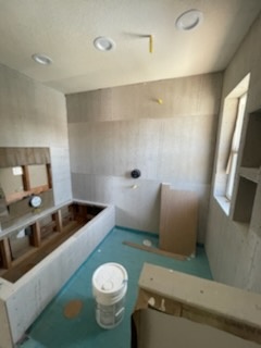 R&B project: bathroom under construction with a tub frame and green floor