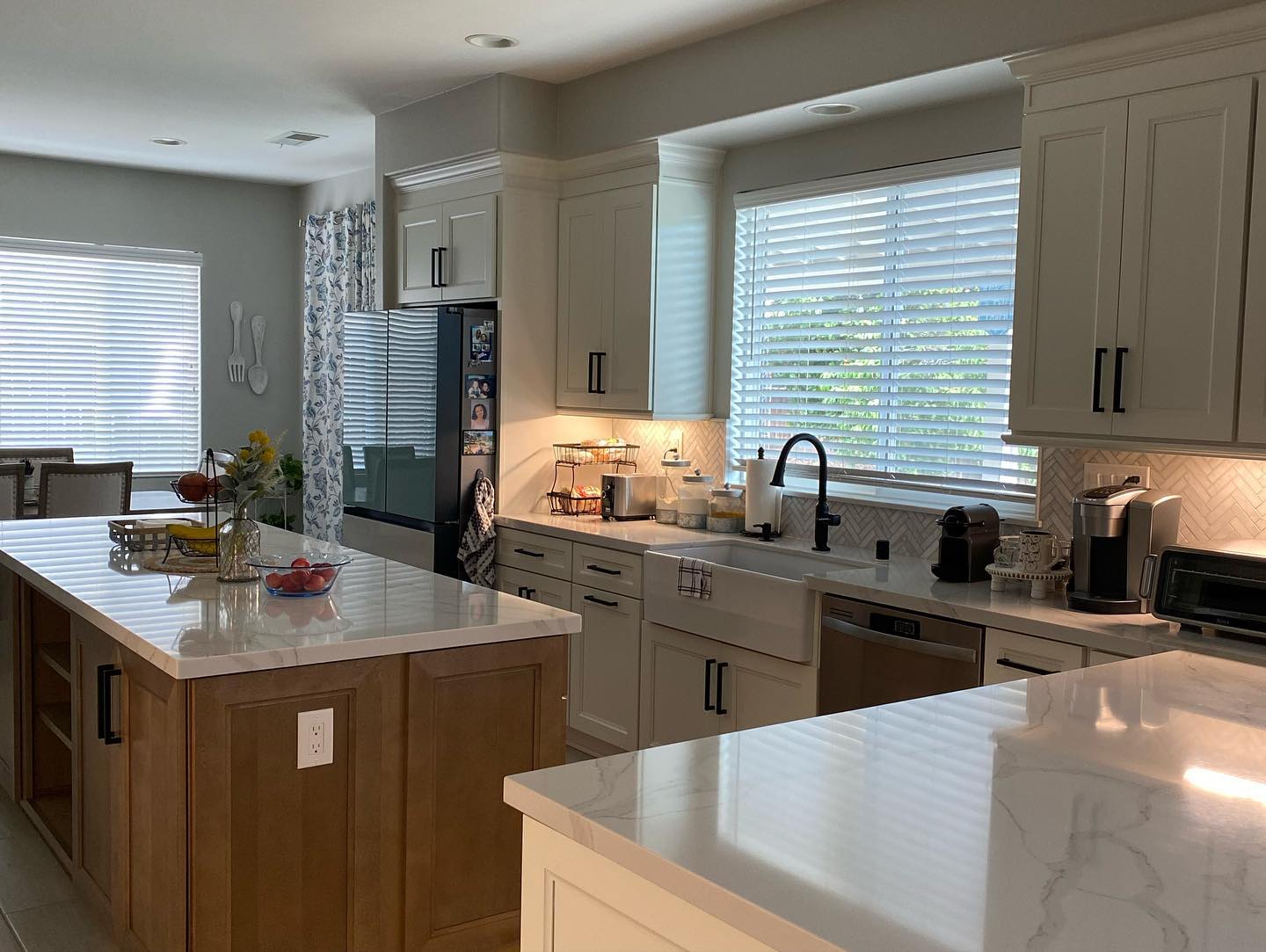 R&B project: white kitchen with a wood island and quartz counters