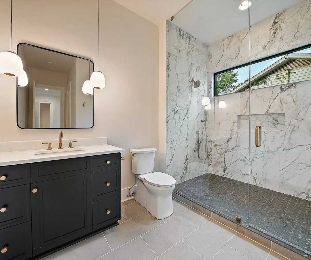 R&B project: black vanity and marble-look walk-in shower