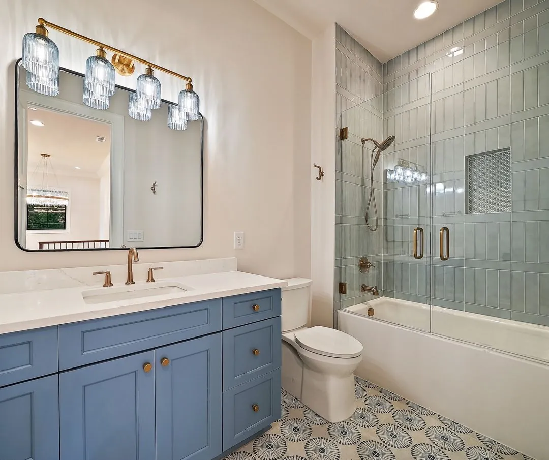R&B project: blue vanity with tiled tub-shower and patterned floor