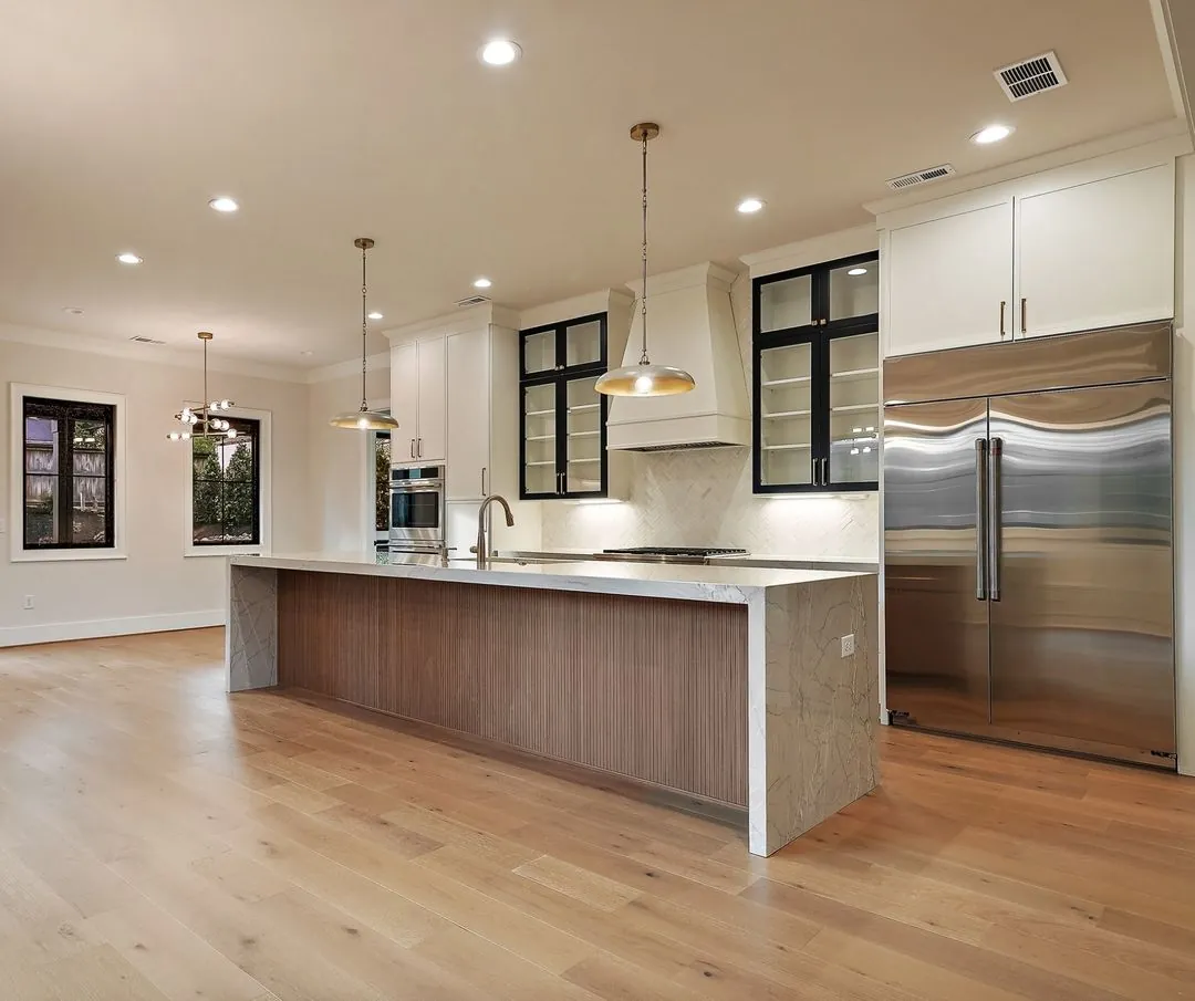 R&B project: kitchen with walnut-paneled island and stainless refrigerator
